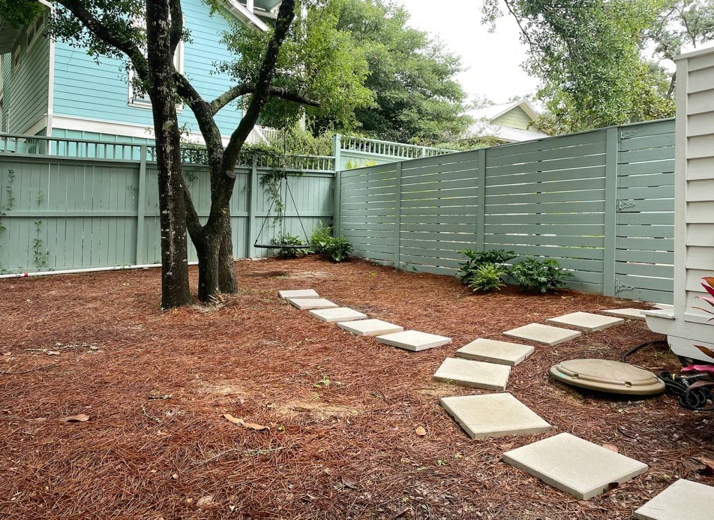 Concrete Pavers Leading To Fence And Swing
