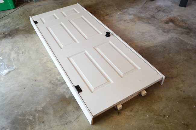 Paneled Door Loosely Fit In Layout Of Hands-on Door Jamb On Garage Floor