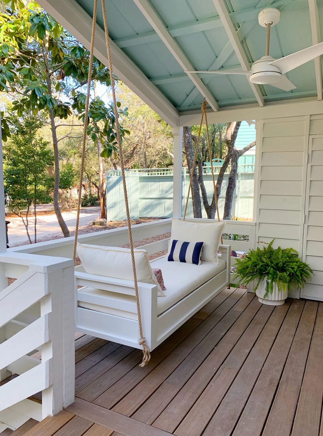 Angled View Of Wrapped up Outdoor Hanging Daybed With White Cushions