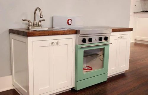 A Cute Play Kitchen Alongside Light-Up Burners