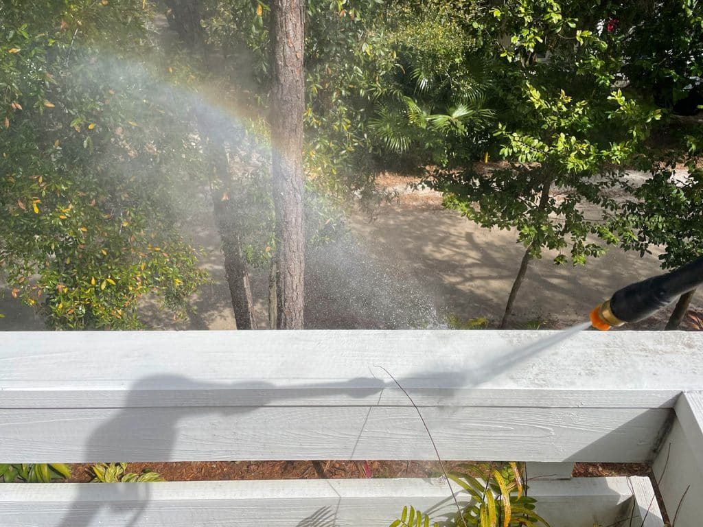 Rainbow created by overspray during pressure washing railings on deck