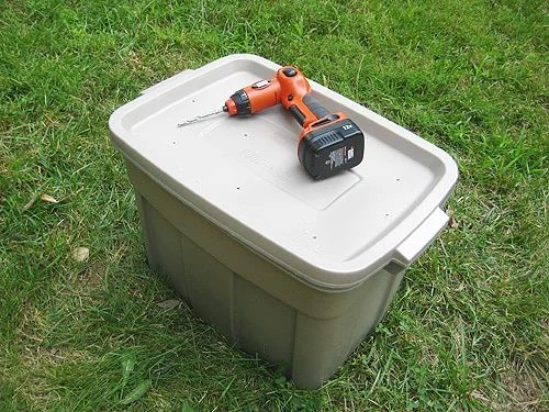 completed hands-on compost bin in plastic container with holes in top