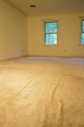 old wrinkled carpet in bedroom