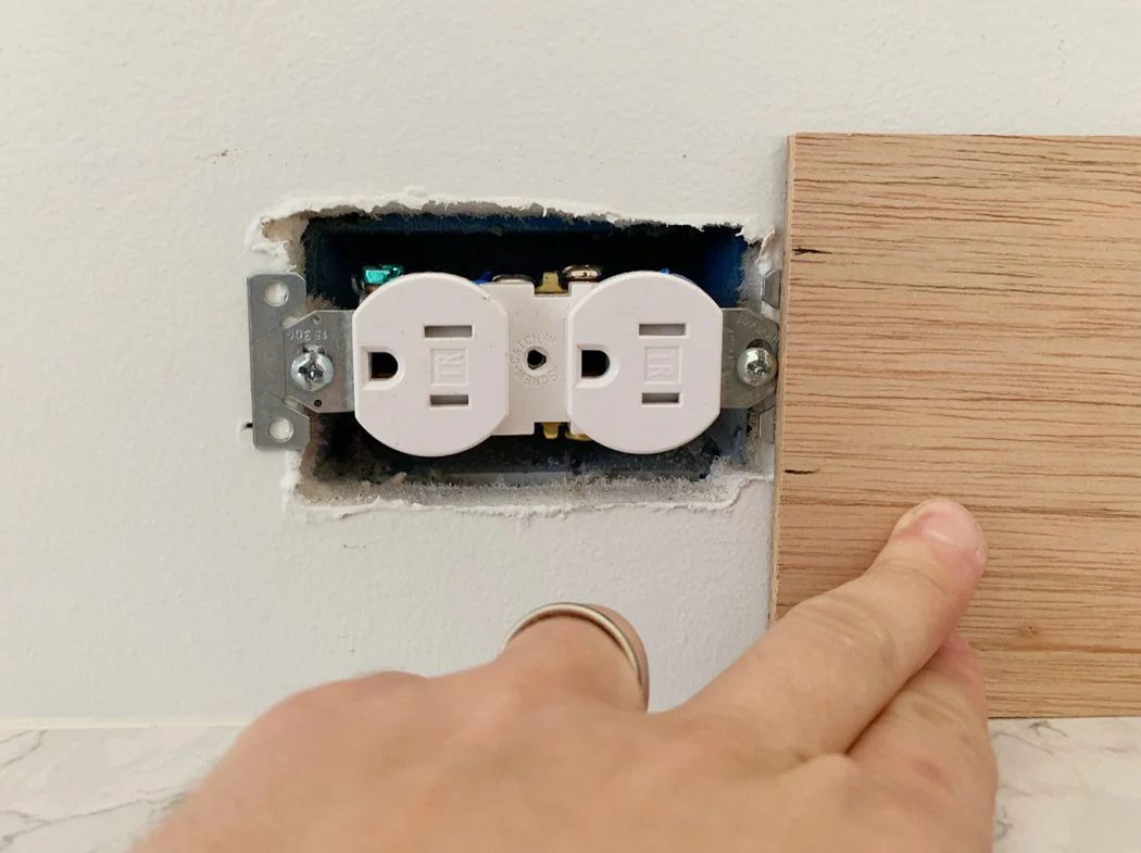 Height Of Electrical Outlet Marked Using Scrap Wood Panel