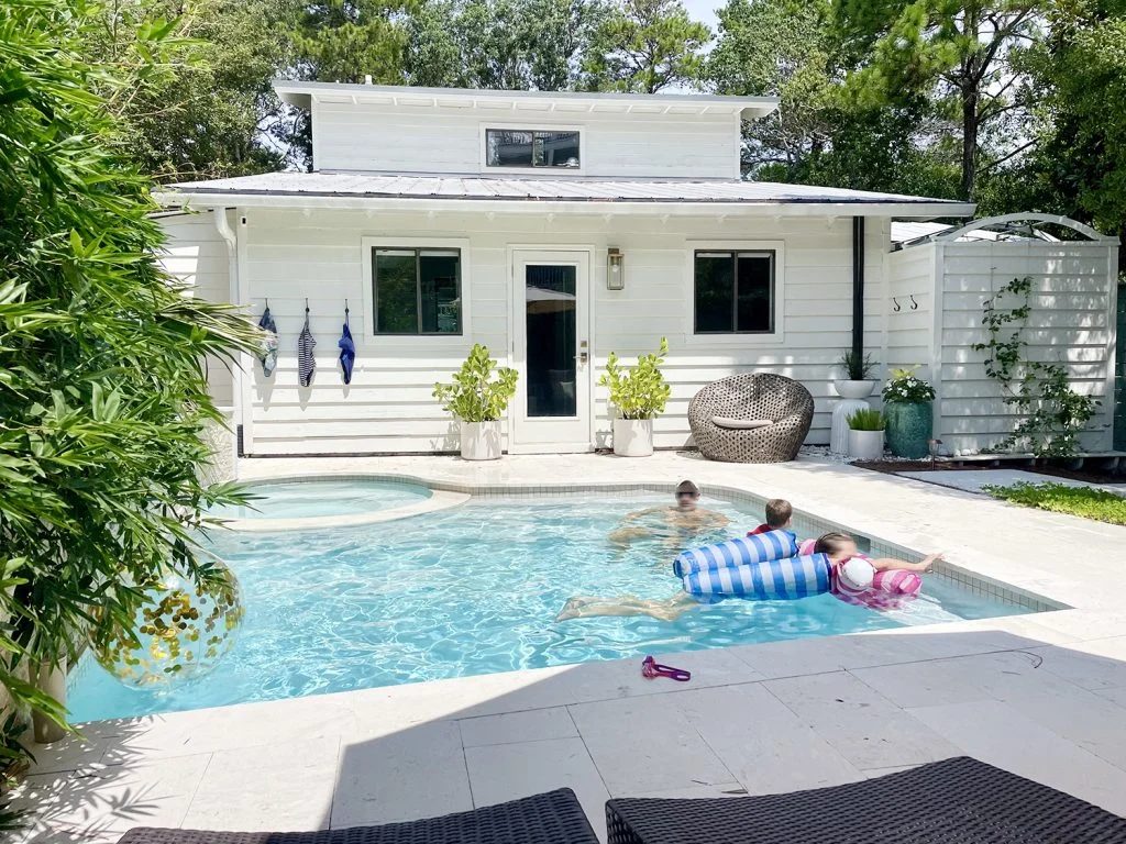 John and kids swimming in backyard pool