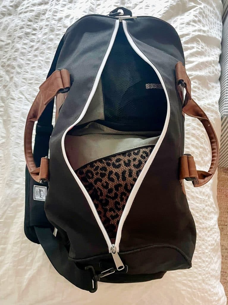 Overnight duffel bag packed with packing cubes on bed