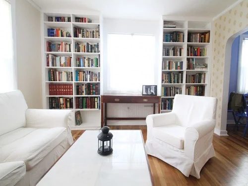 Adding White Built-In Bookcases Around A Window: a house log