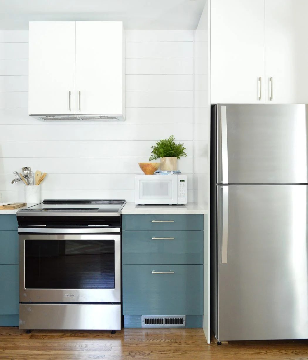 White Planked Wall Shiplap With Blue Ikea Cabinets