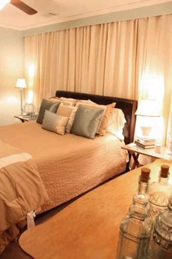A Bedroom Makeover Alongside Curtained Closets Flanking The Bed