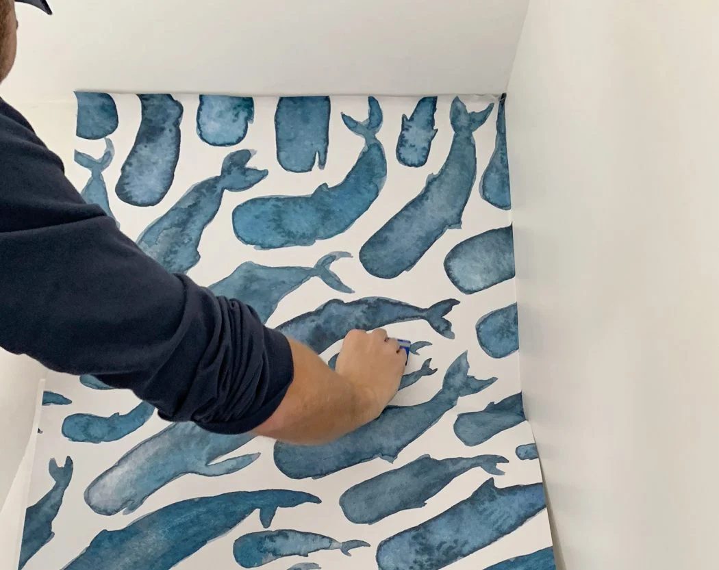 Applying First Panel of Peel And Stick Wall Mural With Overlap at Ceiling