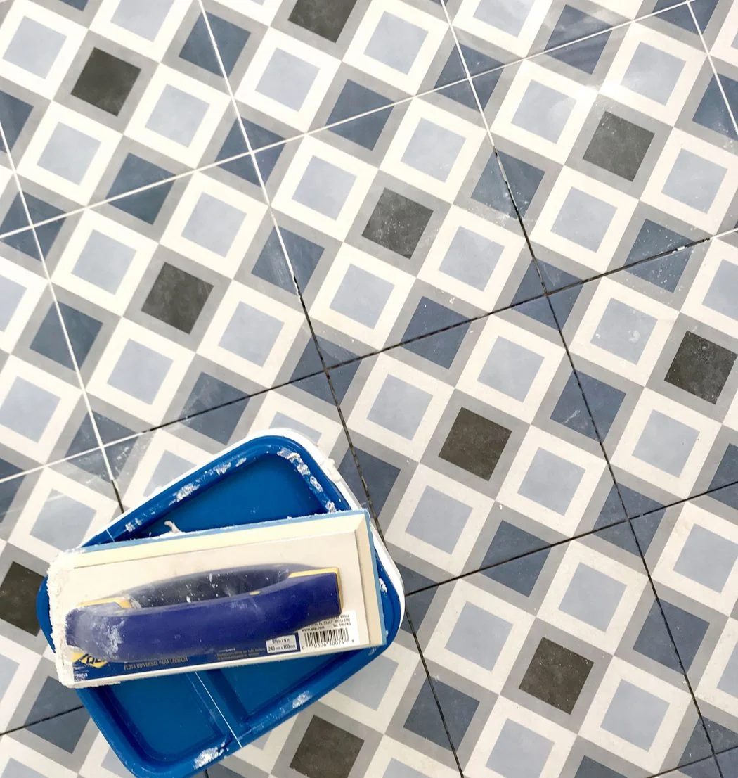blue diamond floor tile getting grouted with frost color mapei flexcolor