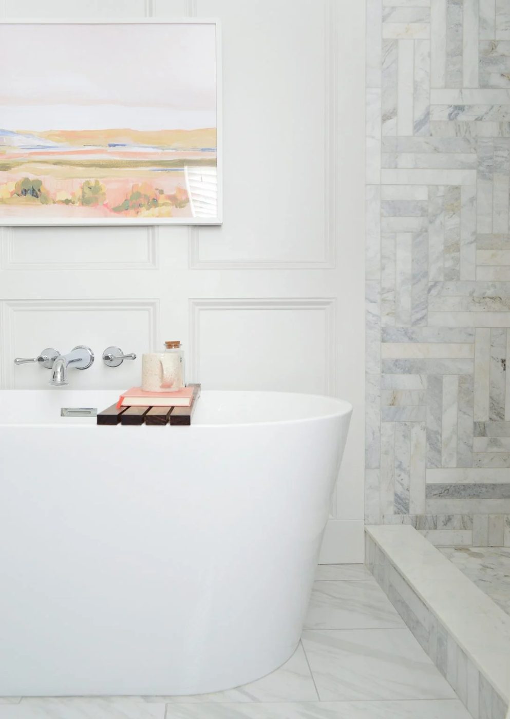 Freestanding tub side view in modern bathroom with marble shower