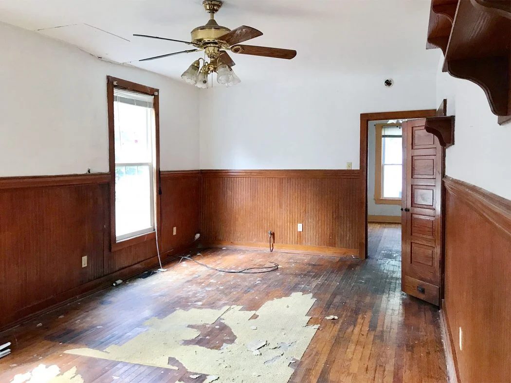 Before photo of living room in historic beach duplex in Cape Charles Virginia