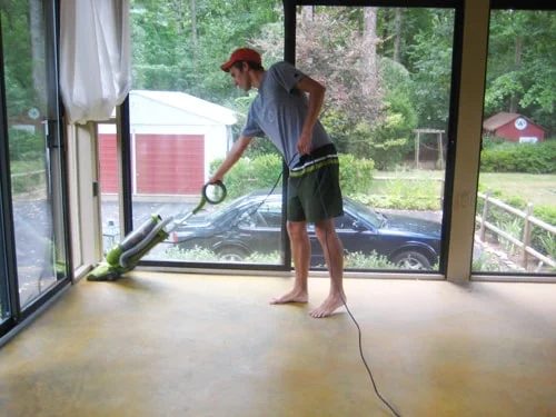 cleaning concrete floor in glass doored sunroom prior to Hands-on stain application using a vacuum
