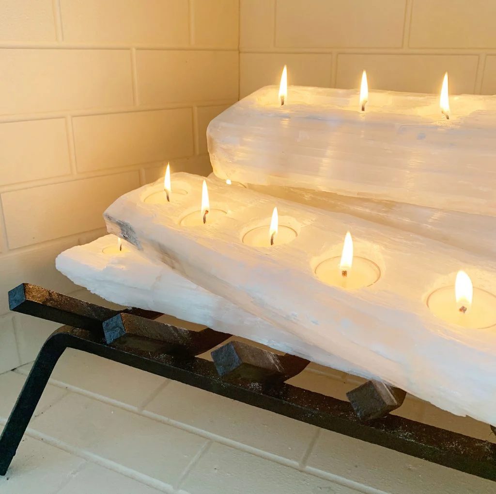 Close-up of tealight holder crystal logs with candles lit
