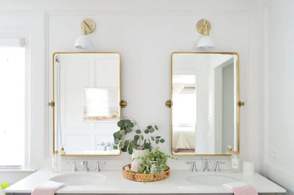 Brass Mirrors Over Vanity With Decorative Wall Molding Treatment Frame