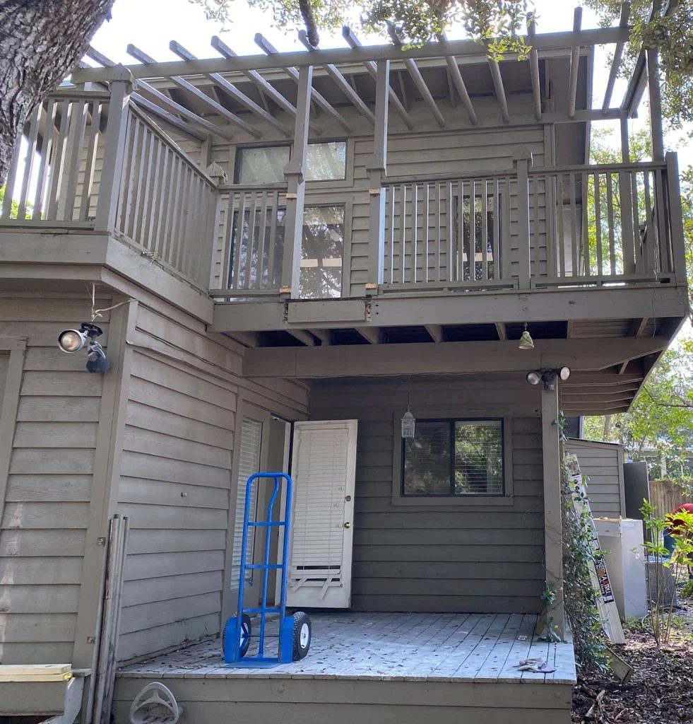 Before photo of side porch with brown paint and staircase took out