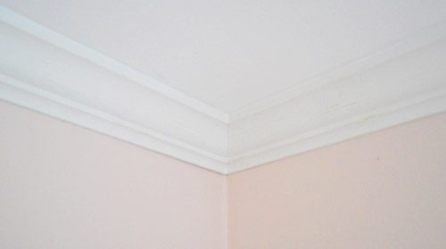 Wrapped up ceiling corner with crown molding installed after caulk
