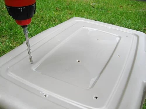 drilling holes in bottom of hands-on compost bin