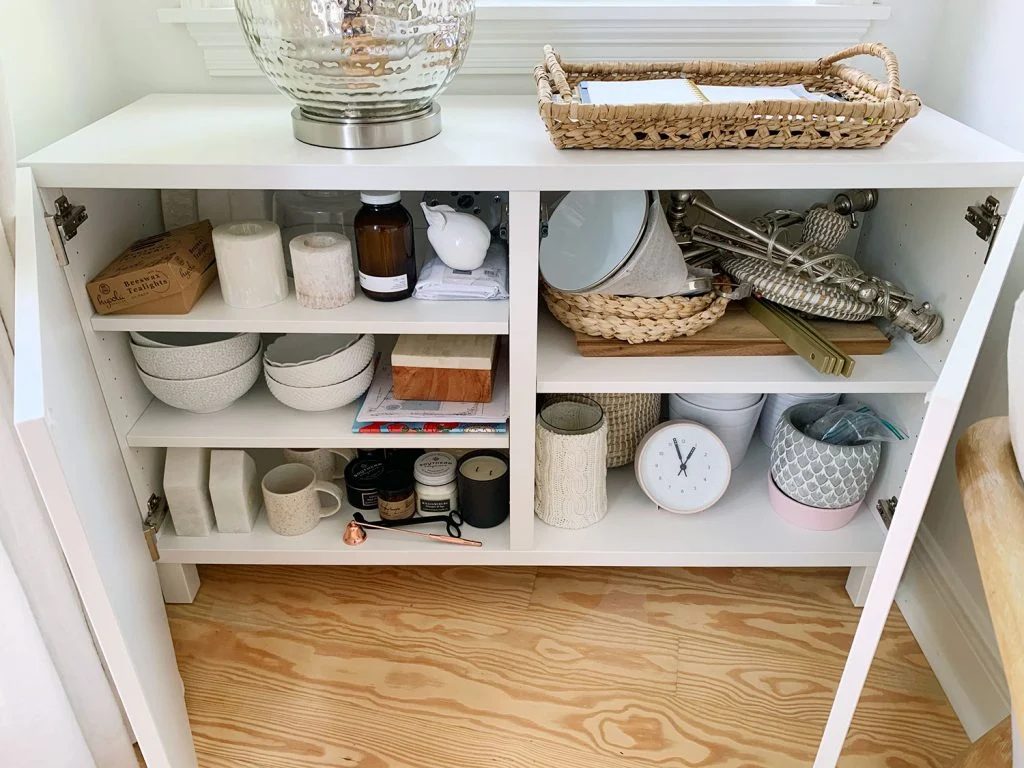 Besta Cabinet Opened With Various Decor Accessories On Shelves
