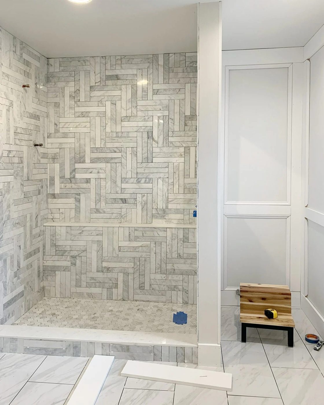 Unpainted Decorative Wall Molding In Master Bathroom With Tiled Marble Shower