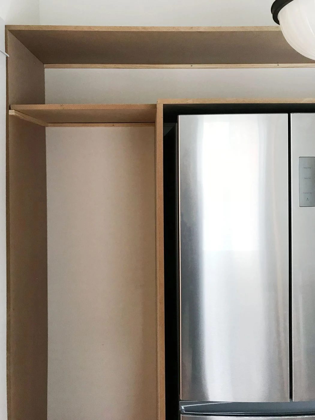 front view of pantry shelves with top shelves already brought in
