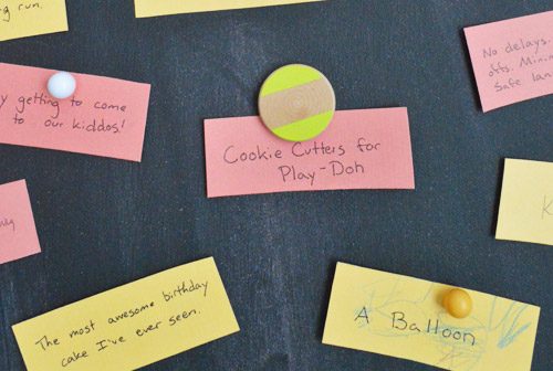Colorful Thanksgiving themed gratitude notes held to magnetic Hands-on chalkboard
