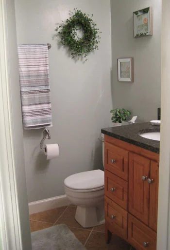 A Sage Green Bathroom Reno Alongside Neutral Tile