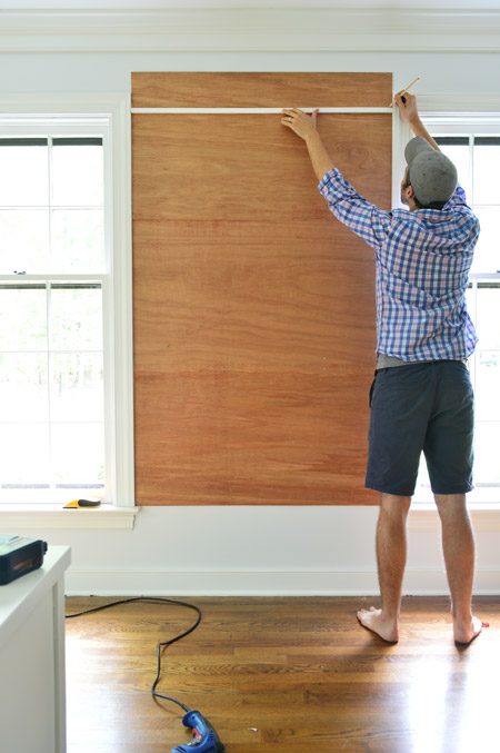 marking cut for top plywood piece for cork board wall so that it does not extend higher than the window frame
