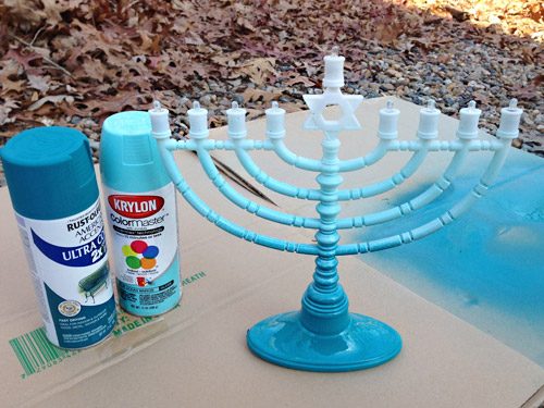 Two cans of blue spray paint for Hands-on Menorah painting holiday project for gradient effect