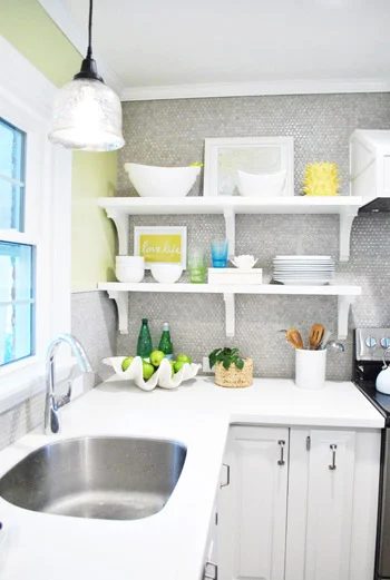 A Kitchen Makeover Alongside Penny Tile And Open Shelves
