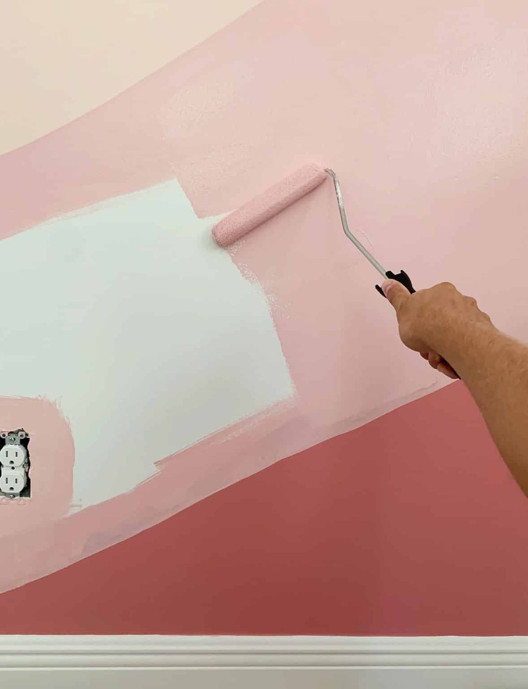 Filling in abstract mural with paint roller