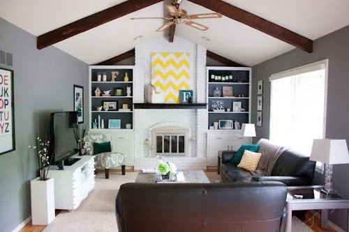 A Painted White Brick Fireplace In A Vaulted Living Room: a house log