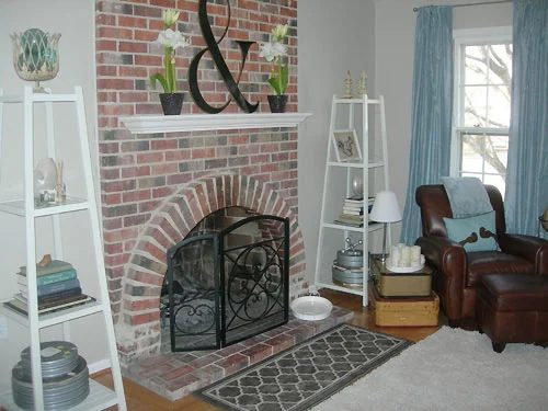 A Family Room Alongside A Brick Fireplace And Blue Curtains