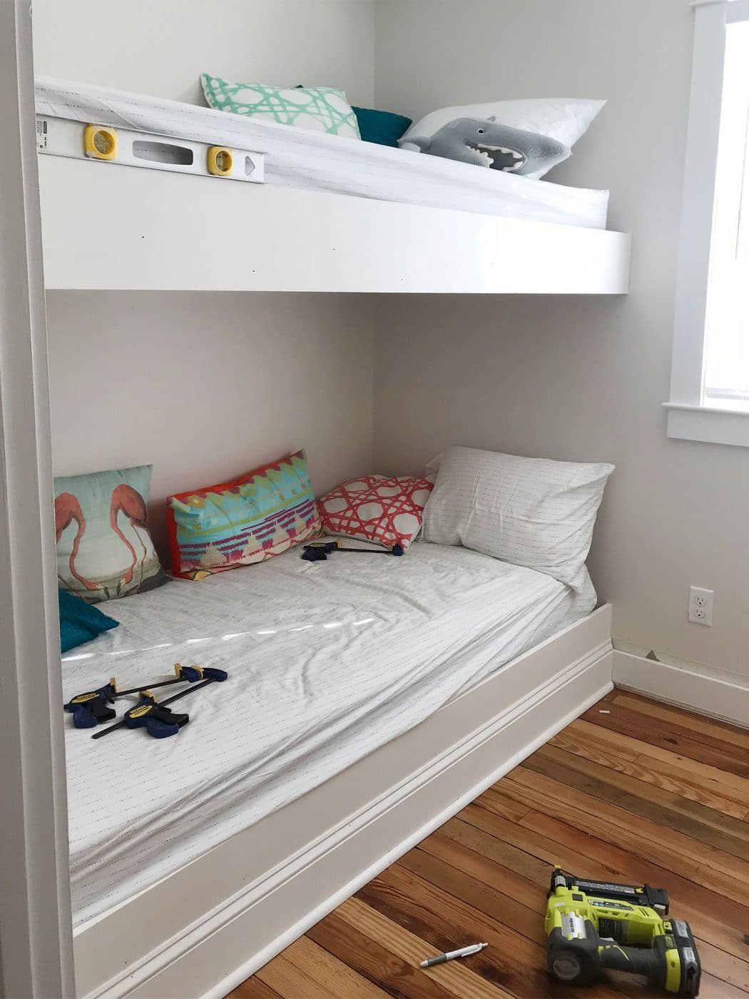 white trim pieces brought in to the face of bunk bed platforms