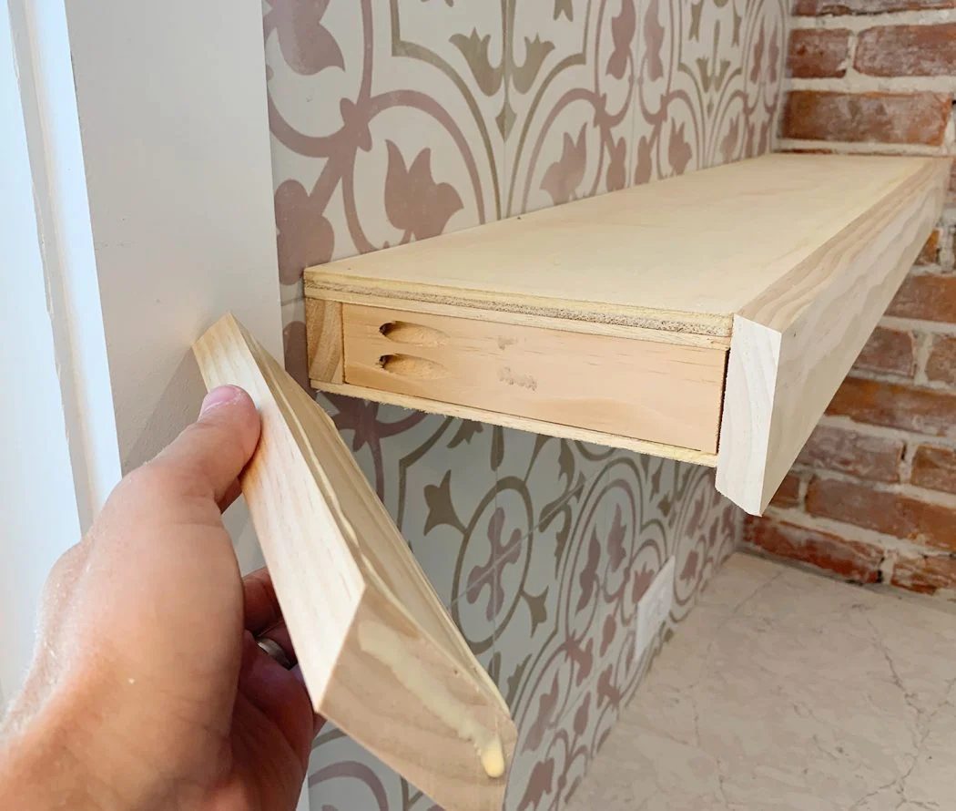 Hand Adding Side Trim Piece To Hands-on Floating Kitchen Shelves