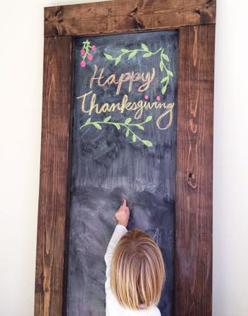 Oversized Hands-on chalkboard with Glad Thanksgiving message drawn in chalk