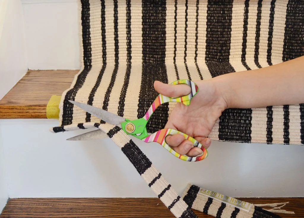 Using scissors to trim off excess runner