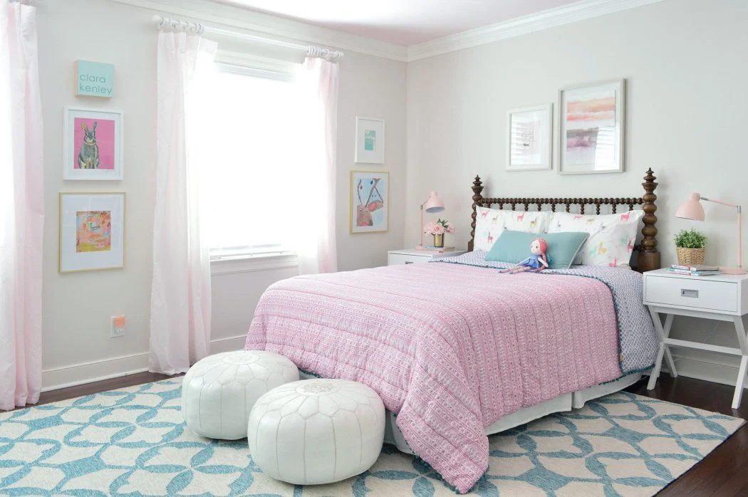 Girl's Bedroom With Wood Spindle Bed And Blue Rug And Pink Bedding