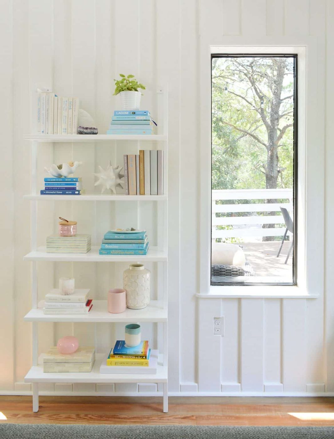 Tall Bookcase Against Wall In Beach Living Room