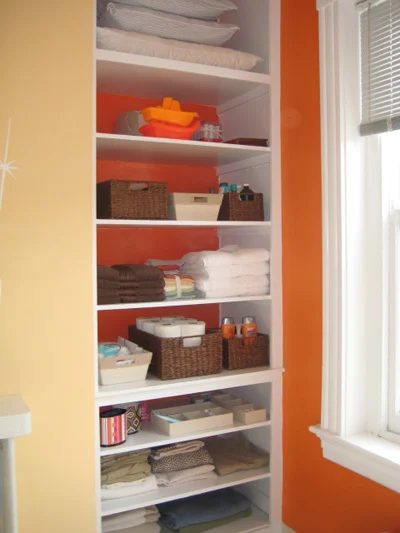 Taking The Doors Off A Bathroom Linen Storage Meant for Open Shelving