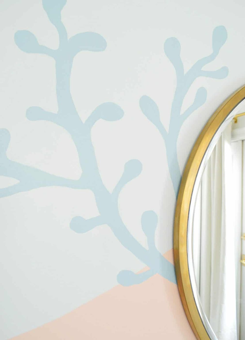 Blue coral shape painted onto abstract mural in beachy girls bedroom