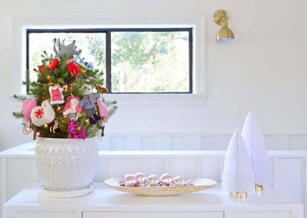 Whit Tabletop With Small Tree Shiny Ornaments And Bottlebrush Trees