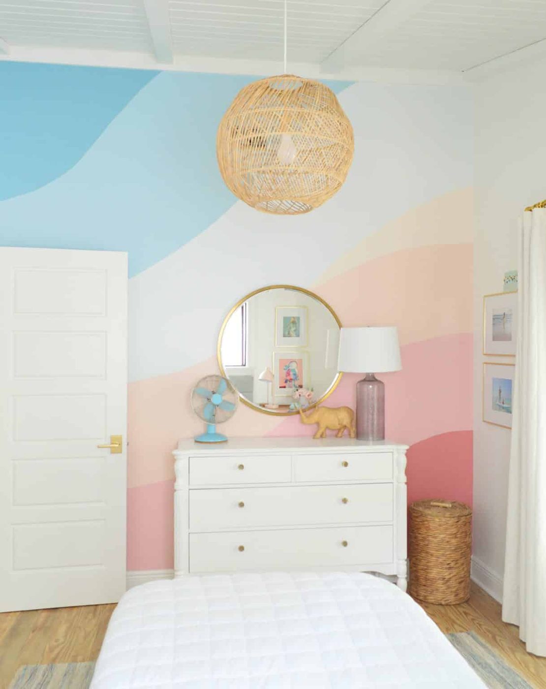 Abstract painted mural in girls bedroom with pink and blue gradient stripes