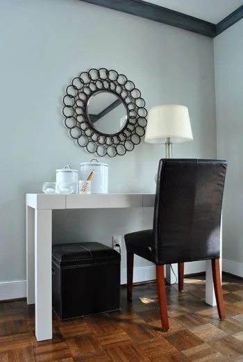 A Round Mirror Over The Desk
