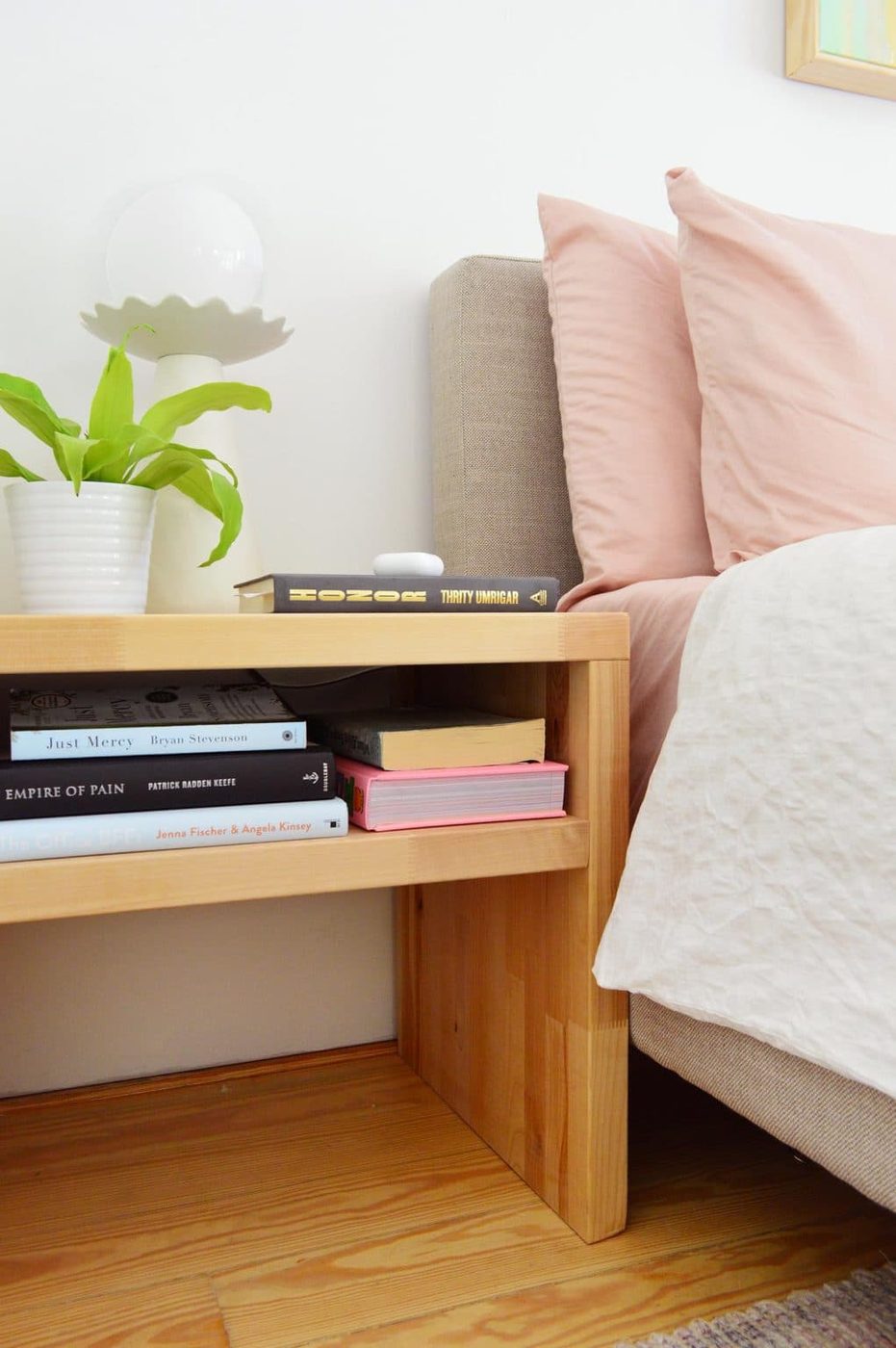 Hands-on Butcher Block Nightstand With Single Shelf Next To Upholstered Bed