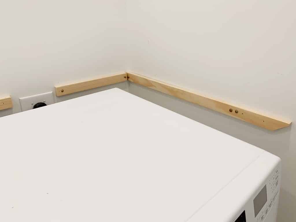 Side view of wall support for Hands-on laundry shelves
