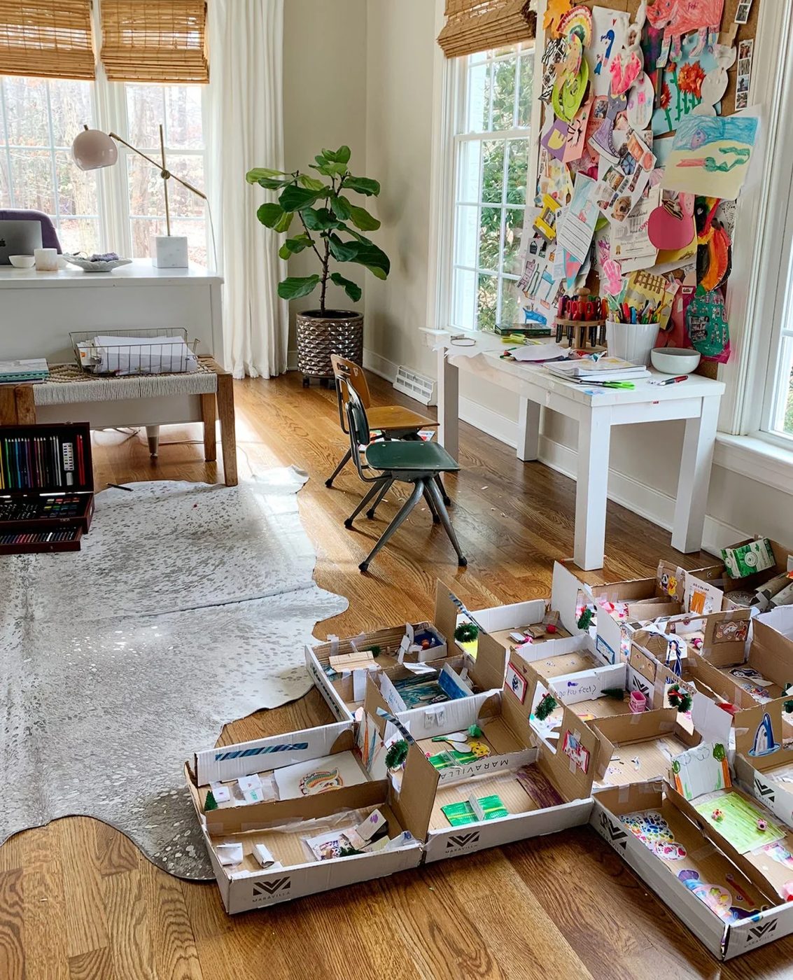Large Cardboard Creation On Ground Next To Small Art Desk Space In Adult Home Office