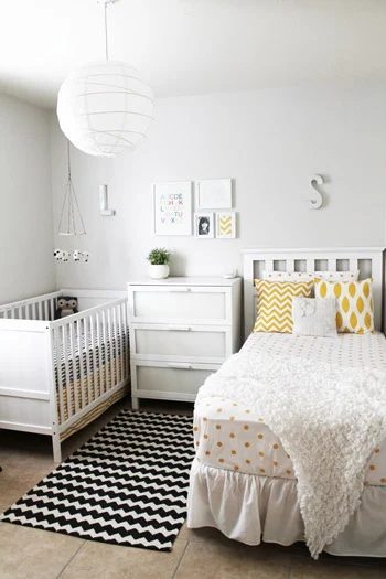 A Shared Nursery Alongside A Crib & A Bed