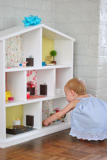 Little girl playing with Straightforward to Made Hands-on Dollhouse